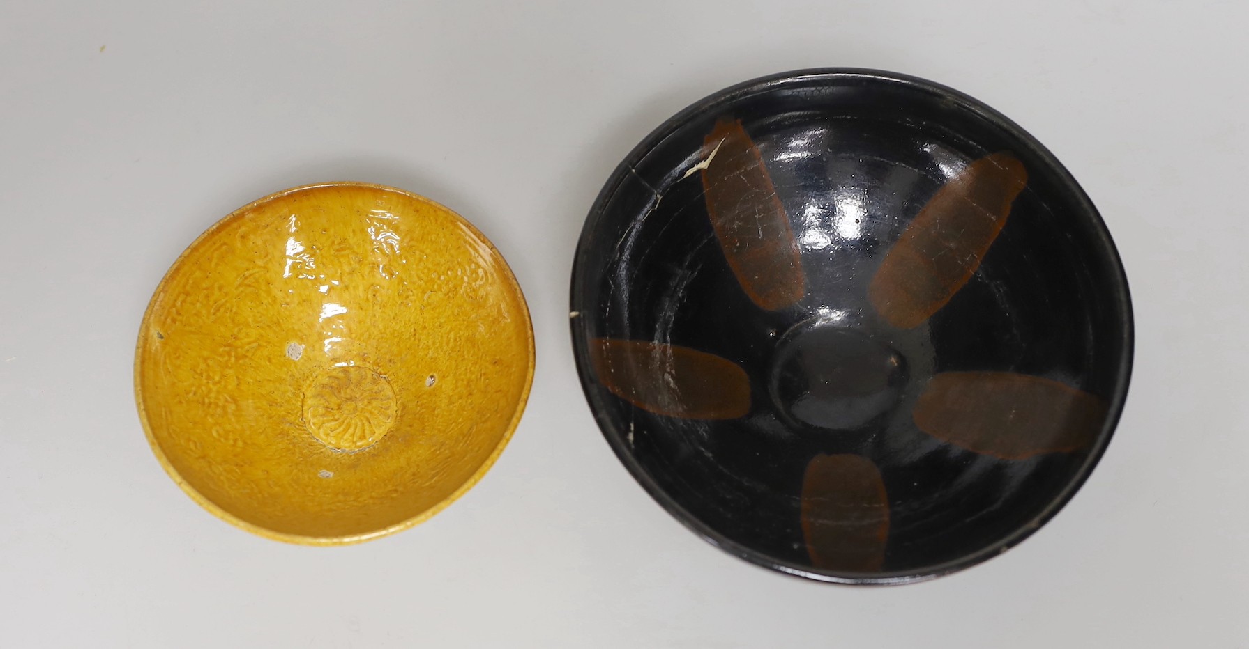 A Chinese amber-glazed pottery conical bowl with moulded floral decoration, Liao dynasty and a Cizhou black and russet glazed bowl, Song dynasty. (2) The Liao bowl from a 1980's Buckinghamshire collection